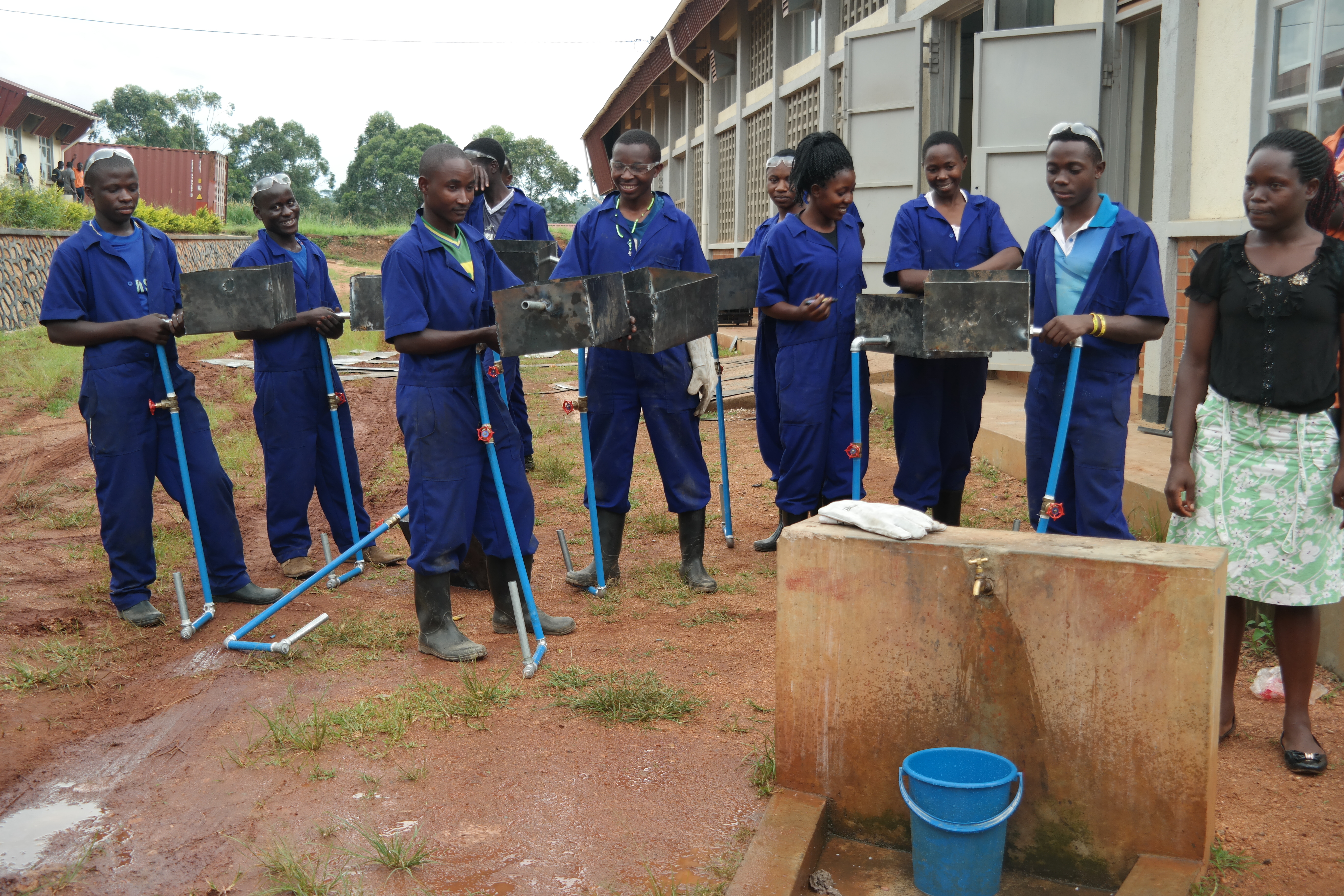 Students assembling shower pipe systems at St. Peter's VTI Mubende